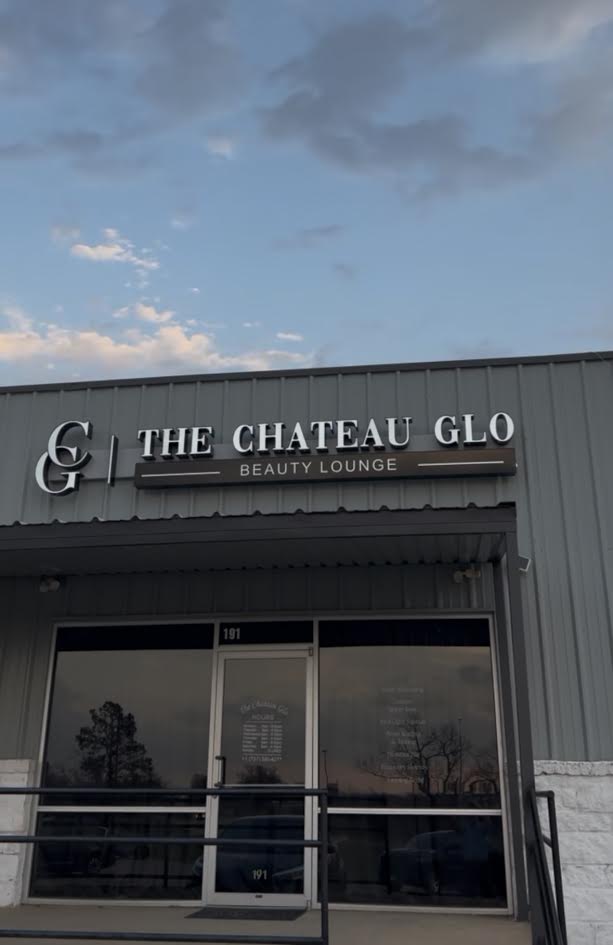 Front entrance of The Chateau Glo Beauty Lounge beneath the storefront sign